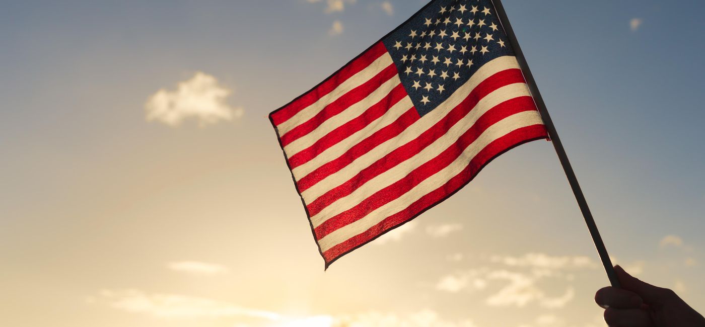 Image: PHOTO: A person holding the American flag. (photo via kieferpix/iStock/Getty Images Plus)