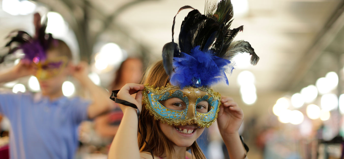 Image: Masked girl at parade. (Photo Credit: Chris Granger of NewOrleans.com)