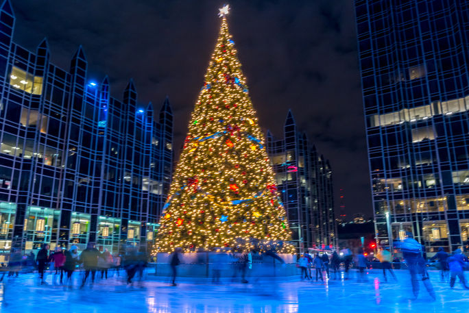 People ice skating around a Christmas tree in Pittsburgh