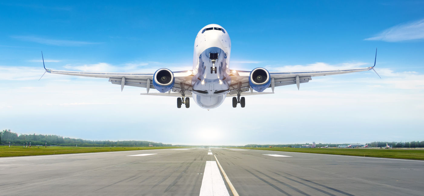 Image: Passenger airplane landing on a runway. (Photo Credit: Adobe Stock/aapsky)