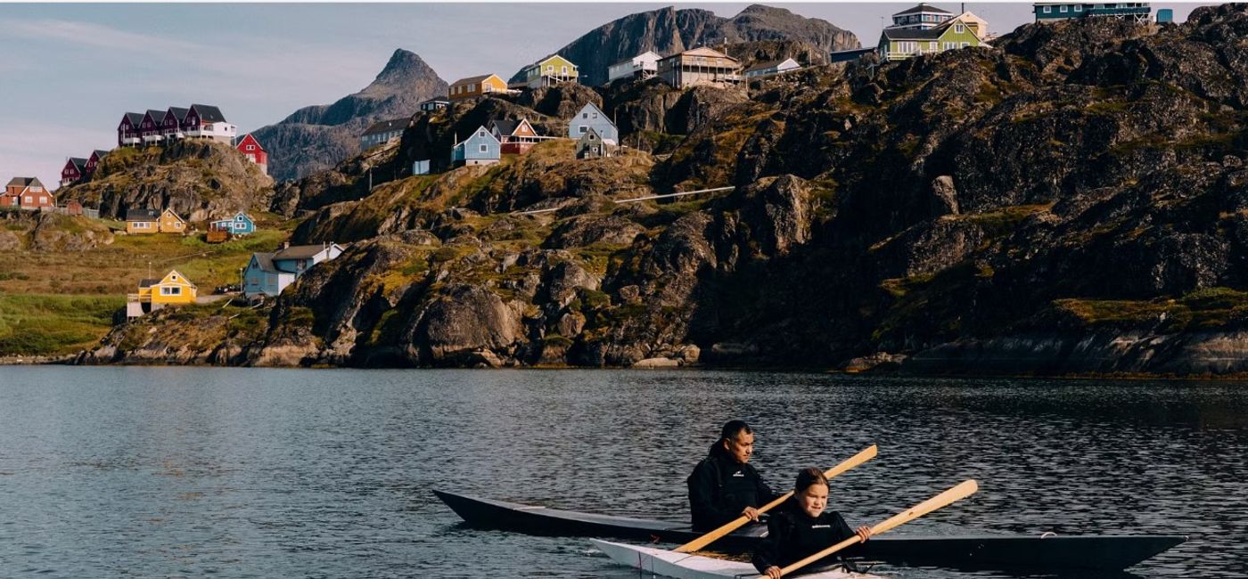 Image: Jacob Peter, with a family member, is a Greenland Kayak maker and part of HX's new Kalaallit Portraits of Greenland series. (Photo Credit: HX Expeditions)