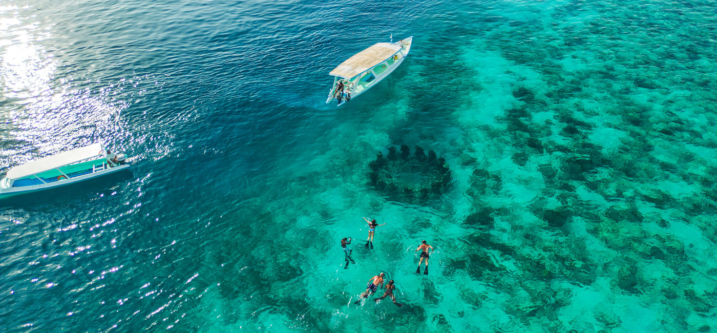 Image: Young adults can snorkel in crystal-clear waters in Indonesia with Contiki. (Photo Credit: Contiki)