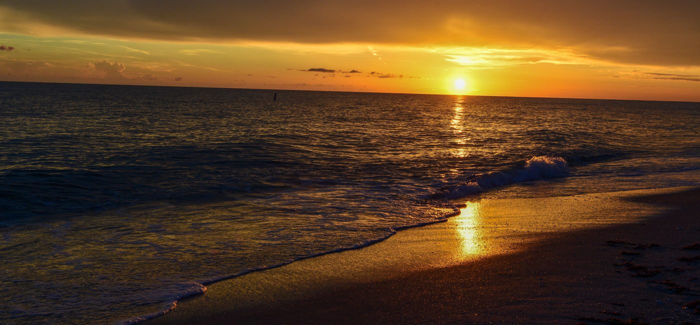 Image: A picturesque sunset on a beach. (Photo Credit: Adobe/Jim)