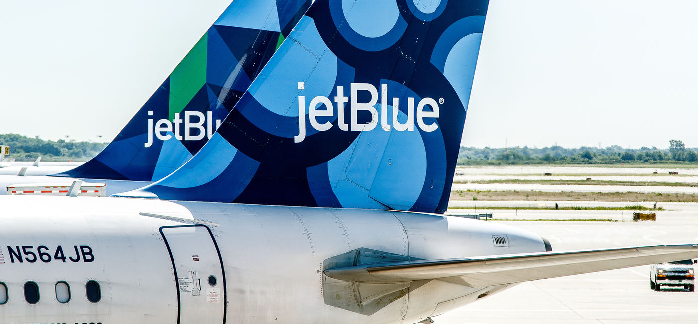 Image: Two JetBlue airplanes parked. (Photo Credit: Roman Tiraspolsky / Adobe Stock)