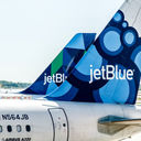 Two JetBlue airplanes parked.