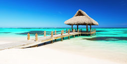 Beautiful gazebo on the tropical white sandy beach in Punta Cana, Dominican Republic (Photo via  Preto_perola / iStock / Getty Images Plus)