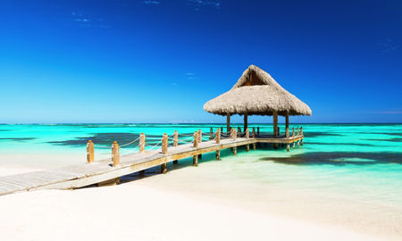 Beautiful gazebo on the tropical white sandy beach in Punta Cana, Dominican Republic (Photo via  Preto_perola / iStock / Getty Images Plus)