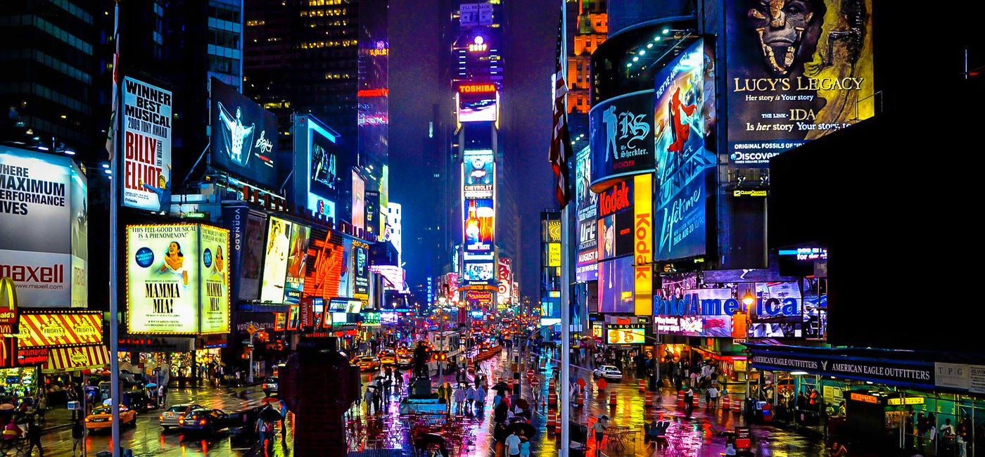 Image: Times Square in New York City on a rainy night (Photo via schalkm / iStock / Getty Images Plus)