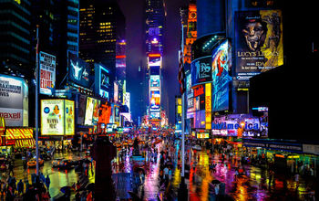 Times Square in New York on a rainy night. (schalkm / iStock / Getty Images Plus)