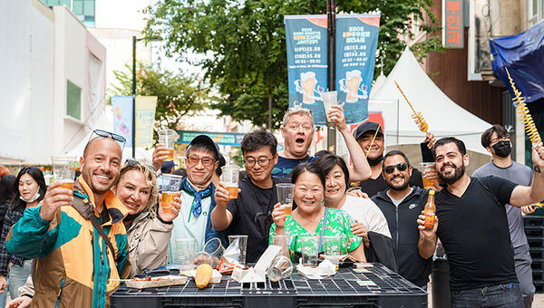 Tourists of all nationalities raising a toast to good food and beer at the 2023 Myeongdong Beer Festival.