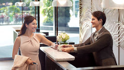 A business guest checking in at Momentus Hotel Alexandra.