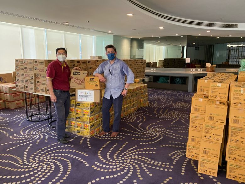 MAH CEO Yap Lip Seng (right) handling the aid cartons with MAH Selangor chapter secretariat Francis Alberto.