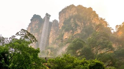 The Sky Ladder is a via ferrata trail with steel handrails, footrests, tethers, and cables, located in Zhangjiajie Nature Park.