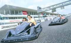 Families can drive electric go-karts on the actual Suzuka F1 racetrack in the “Circuit Challenger” attraction for a rare hands-on experience.