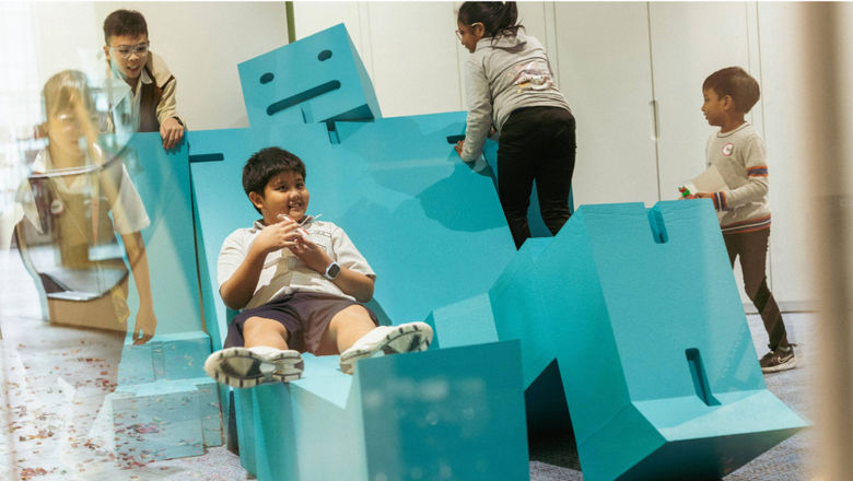 The Cubebot at ArtScience Laboratory is an interactive, modular wooden puzzle toy that can be shaped into different poses or used as seating, blending learning and play in creative ways.