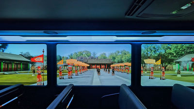 Transparent screens overlay digital scenes onto the live view of Yuanmingyuan Park.
