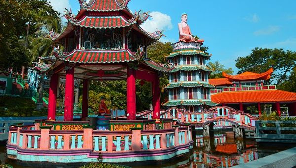 A pavilion with a statue of Buddha in Haw Par Villa. A pavilion with a statue of Buddha in Haw Par Villa.