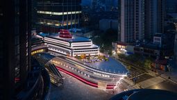 The Louis is a chrome, ship-shaped cultural landmark in Shanghai featuring exhibitions, a café, and luxury retail across three storeys.