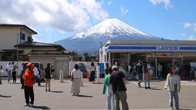 The Lawson convenience store's juxtaposition against Mount Fuji creates visually appealing photos, attracting hordes of tourists to Fujikawaguchiko town.