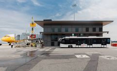 This facility streamlines remote flight boarding by providing sheltered access between buses and  aircraft via aerobridges.