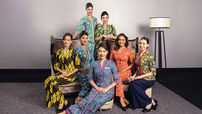 Cabin crew show off the six styles of sarong kebaya worn by Malaysia Airlines cabin crew over the last 50 years.