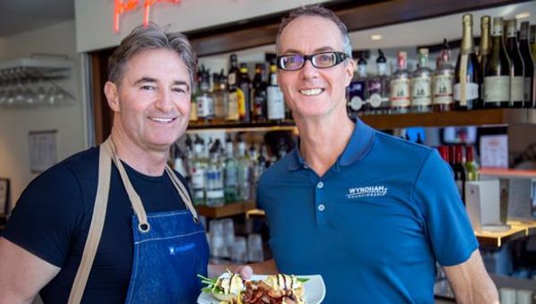 Barry Robinson, president and managing director, international operations Wyndham Destinations (left), and Bruce Harkness, senior vice president, HR, brand communications and customer experience, get to work in the kitchen. Barry Robinson, president and managing director, international operations Wyndham Destinations (left), and Bruce Harkness, senior vice president, HR, brand communications and customer experience, get to work in the kitchen.