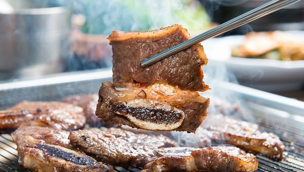 Beef galbi is a Korean dish featuring marinated short ribs grilled to perfection, offering a sweet and savoury flavour with tender, smoky meat. Beef galbi is a Korean dish featuring marinated short ribs grilled to perfection, offering a sweet and savoury flavour with tender, smoky meat.