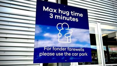 Dunedin Airport has installed signs to remind travellers of the three-minute limit on farewell hugs.