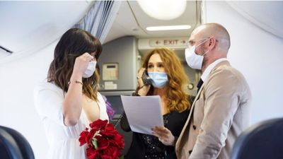 Elaine Tiong and Luke Serdar at their wedding onboard a Virgin Australia flight, with Australian actress Tottie Goldsmith as celebrant for the ceremony.