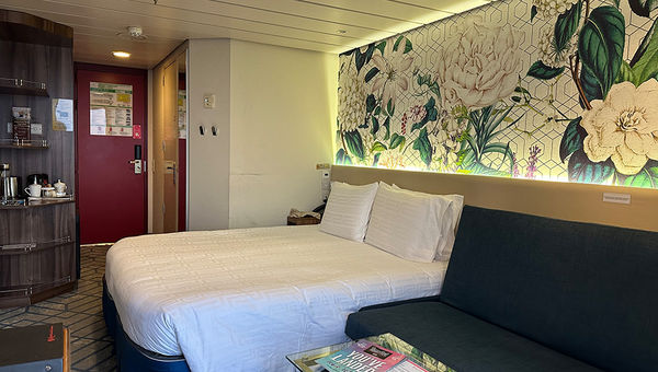 Resorts World One's balcony stateroom features elegant decor, a comfortable bed, spacious seating, modern amenities, and a private balcony offering stunning ocean views for ultimate relaxation. Resorts World One's balcony stateroom features elegant decor, a comfortable bed, spacious seating, modern amenities, and a private balcony offering stunning ocean views for ultimate relaxation.