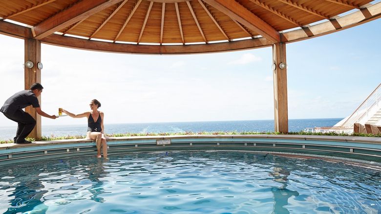 Diamond Princess offers Japanese-inspired amenities, including an Izumi Bath, Noodle Bar, sushi at Kai Sushi, fine Japanese whiskies, traditional storytelling, karaoke, and cultural performances.