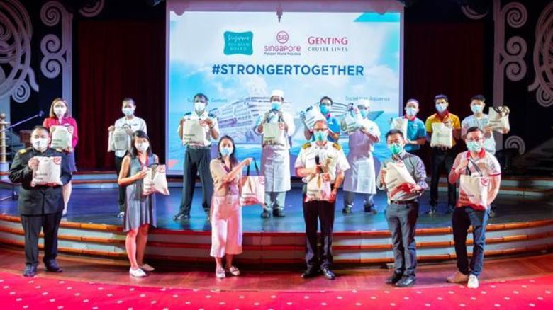 Singapore Tourism Board presenting “Perk-Me-Up” care packs with vitamins and local snacks as a thank you gesture towards the crew members of SuperStar Gemini and SuperStar Aquarius.