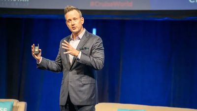 Norwegian Cruise Line's John Chernesky on stage at the 2023 CruiseWorld.