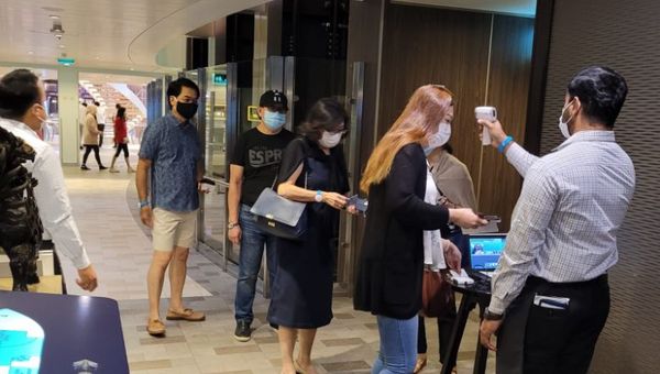 Breakfast queues are orderly, with safety and sanitisation checks in place.