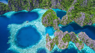 An aerial view of the lagoons and limestone cliffs of Coron, Palawan in the Philippines.