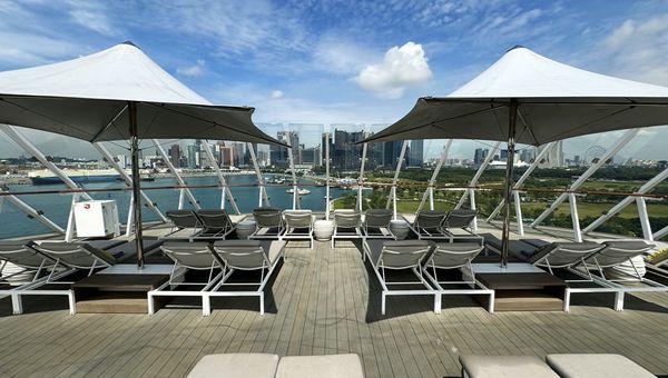 The Retreat Sundeck offers suite-class guests a secluded outdoor area with loungers and cabanas for ultimate relaxation and scenic views.