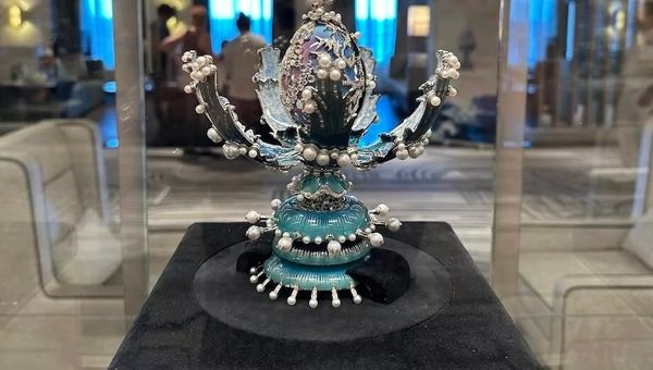 The Fabergé Egg's intricate design, adorned with pearls and diamonds, conceals a rotating hand-painted egg showcasing changing oceanic colours. The Fabergé Egg's intricate design, adorned with pearls and diamonds, conceals a rotating hand-painted egg showcasing changing oceanic colours.