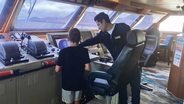 The author's son gets a lesson on the bridge on Lindblad Expeditions' National Geographic Islander II. The author's son gets a lesson on the bridge on Lindblad Expeditions' National Geographic Islander II.