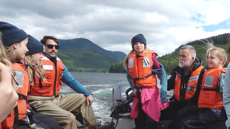 Children learn to drive a Zodiac in Alaska on a Lindblad Expedition-National Geographic sailing, as part of the Global Explorers programme.