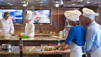 Oceania Cruises' Vista features an expanded Culinary Center with personal cooking stations, offering hands-on classes exploring regional dishes, French gastronomy, dessert creation, and food-beverage pairing.