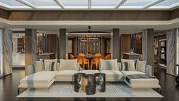 The Skyview Regent Suite’s formal dining area includes a grand table, built-in serving credenzas, a glass-enclosed bar, and a skylight.