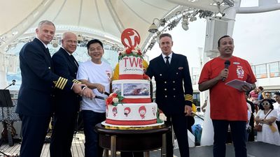 Michael Goh, president of Resorts World Cruises, cutting a cake with ship officers to celebrate the cruise line’s 2nd anniversary.