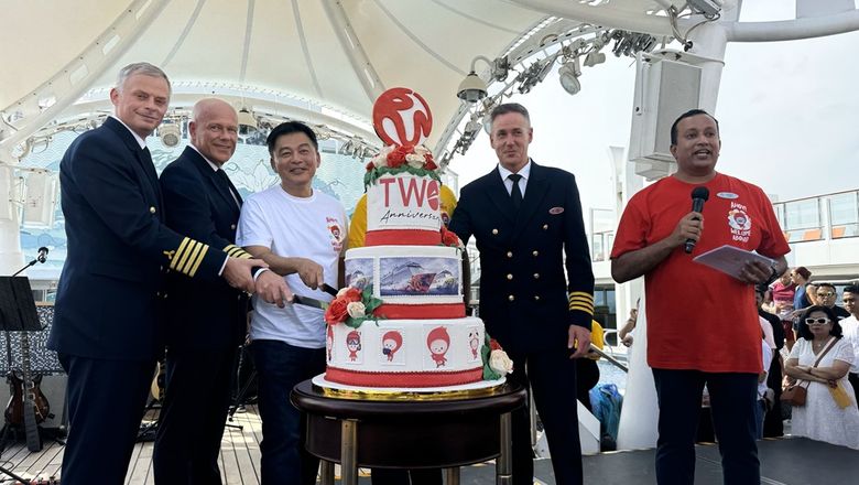 Michael Goh, president of Resorts World Cruises, cutting a cake with ship officers to celebrate the cruise line’s 2nd anniversary.