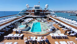 Vista's pool deck boasts a resort-at-sea atmosphere with curved shapes, wooden elements, hot tubs, and six round daybeds.