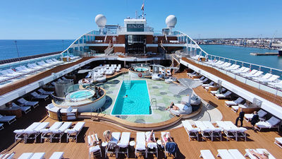 Vista's pool deck boasts a resort-at-sea atmosphere with curved shapes, wooden elements, hot tubs, and six round daybeds.