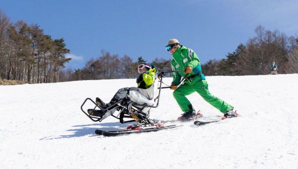 Dual skis enable people with limited mobility to ski with an instructor.