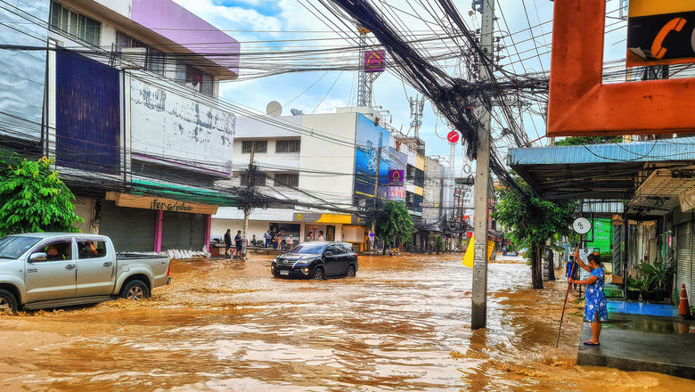 The floods in Chiang Mai were triggered by heavy monsoon rains, causing the Ping River to overflow, worsened by climate change and Typhoon Yagi's earlier impact.