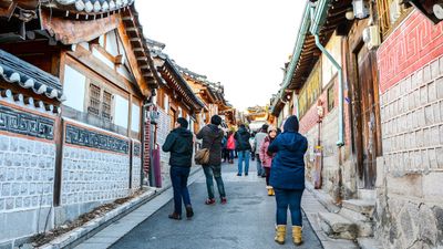 Tourists flock to Bukchon Hanok Village to take photos at the picturesque traditional Korean houses.