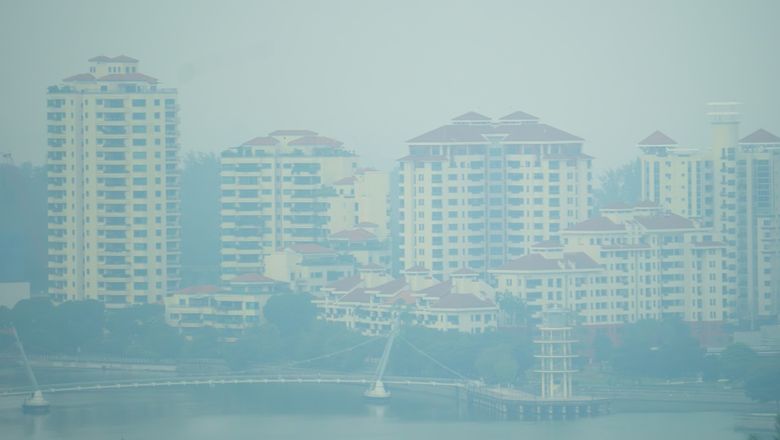 Haze shrouds waterfront residential towers at Tanjong Rhu, Singapore.