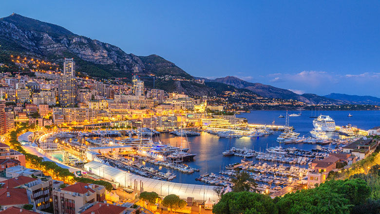 A panoramic evening view of Monte Carlo harbour in Monaco.